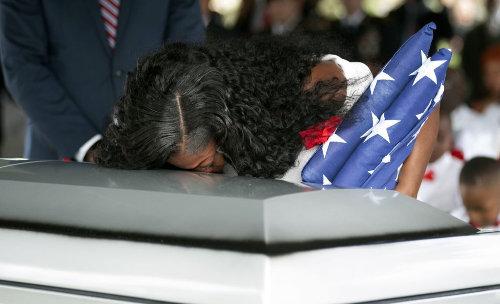 Myeshia Johnson kisses the casket of her husband Army Sgt. La David Johnson during his burial service for at the Memorial Gardens East cemetery on October 21, 2017 in Hollywood, Florida. 