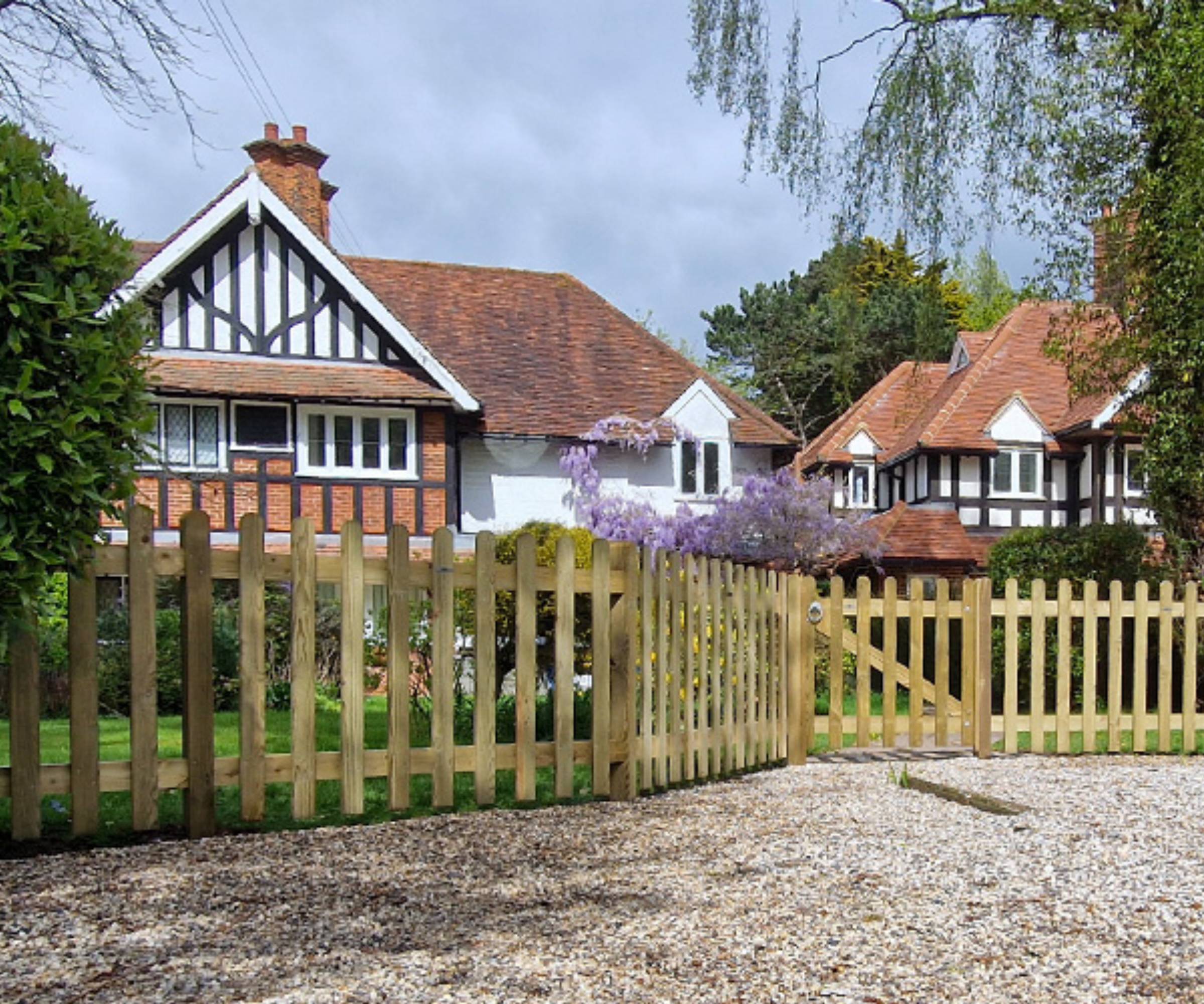 Picket fence outside Tudor-style detached home
