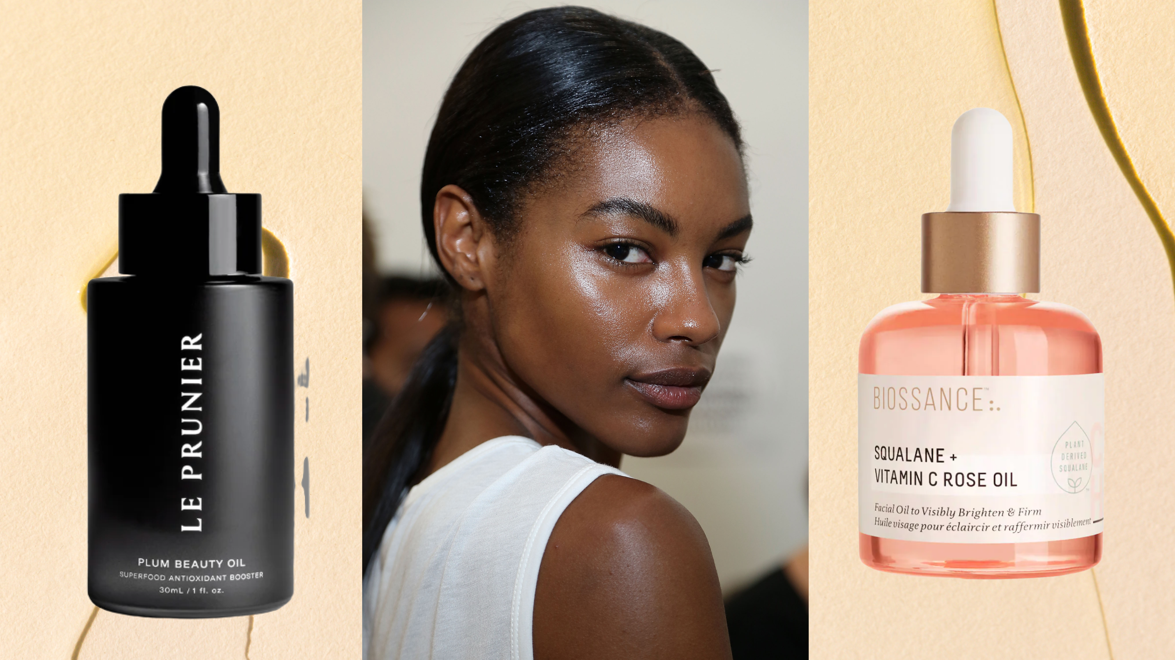A woman with a low ponytail and glowing skin, next to two bottles of face oil. 