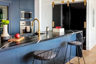 black lacquer barn doors in a kitchen