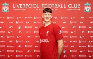 New Liverpool signing Calvin Ramsey signs for the club at AXA Training Centre on June 19, 2022 in Kirkby, England.