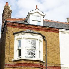 Exterior of Victorian semi detached house with bay windows and a dormer window in the roof