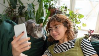 Woman taking picture with cat