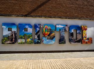 The word Bristol written on a wall covered in artwork