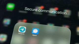 The logos for the Telegram and Signal mobile apps on an iPhone, shown to depict secure messaging services