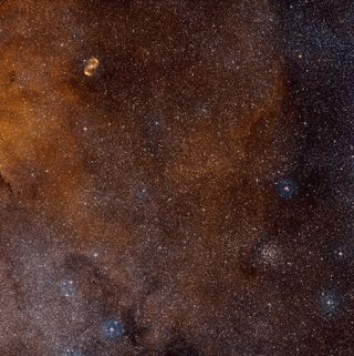This wide-field view shows a region of sky in the southern constellation of Norma (The Carpenter's Square). At the centre lies the massive star-forming region SDC 335.579-0.292, but this is too obscured by dust to be visible. Image released July 10, 2013.