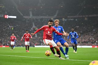 MANCHESTER, ENGLAND - NOVEMBER 10: Bruno Fernandes of Manchester United is challenged by Victor Kristiansen of Leicester City during the Premier League match between Manchester United FC and Leicester City FC at Old Trafford on November 10, 2024 in Manchester, England. (Photo by Michael Regan/Getty Images)