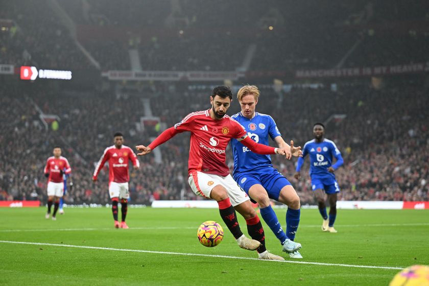 MANCHESTER, ENGLAND - NOVEMBER 10: Bruno Fernandes of Manchester United is challenged by Victor Kristiansen of Leicester City during the Premier League match between Manchester United FC and Leicester City FC at Old Trafford on November 10, 2024 in Manchester, England. (Photo by Michael Regan/Getty Images)