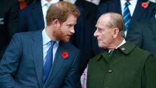 Prince Harry, Prince Phillip and Prince William enjoy the atmosphere during the 2015 Rugby World Cup Final match between New Zealand and Australia at Twickenham Stadium on October 31, 2015 in London, United Kingdom.