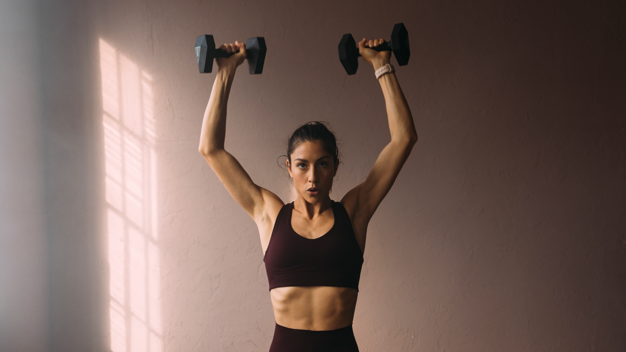 Woman doing dumbbell shoulder press