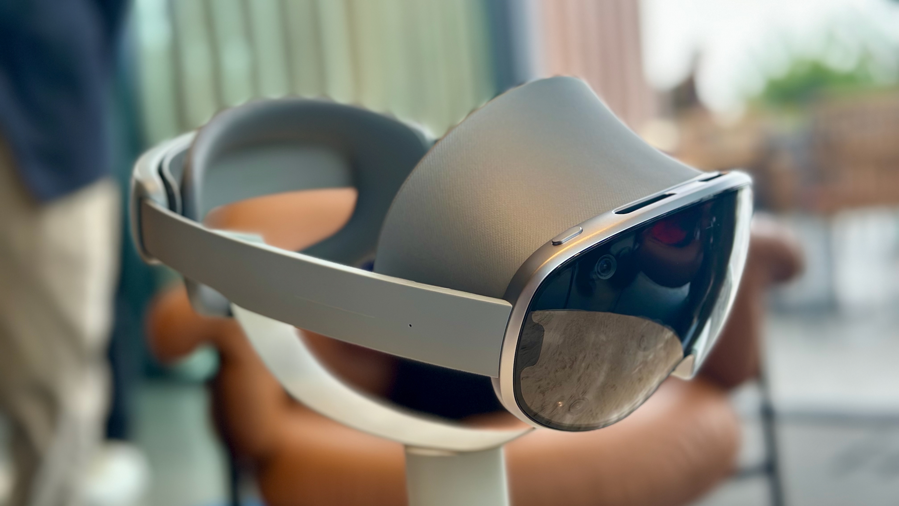 A photo of the Samsung Galaxy XR headset sitting on a pedestal, angled forward and to the right.
