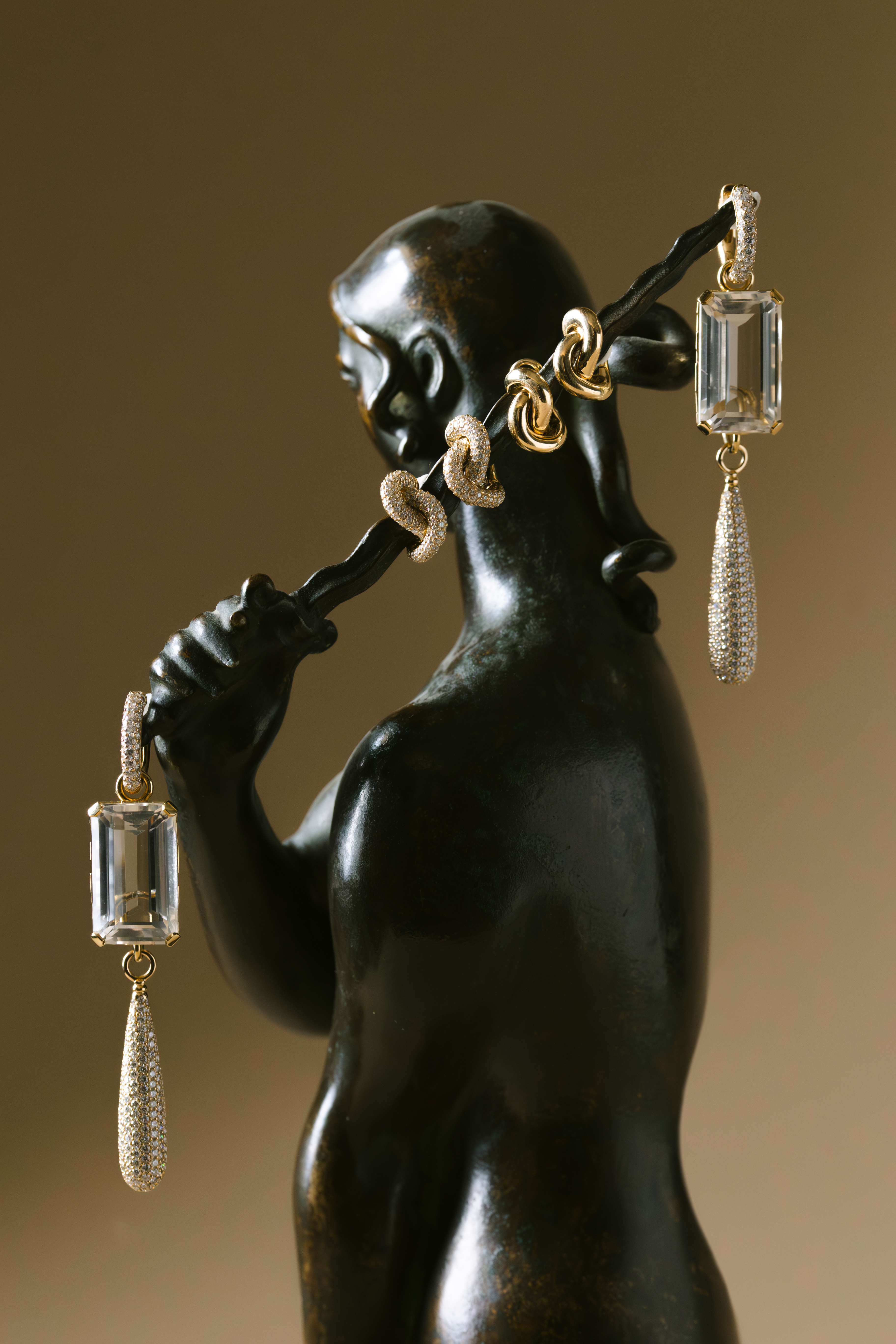 ceramics and jewellery against green and brown backgrounds