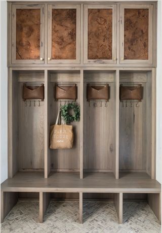 mudroom with leather pocket pouches and cubbies