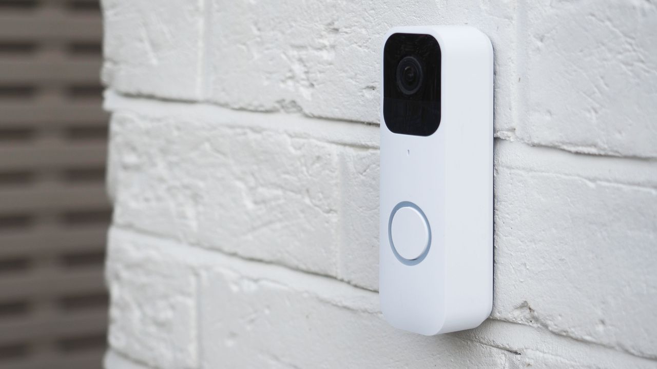 a blink doorbell on a white brick wall