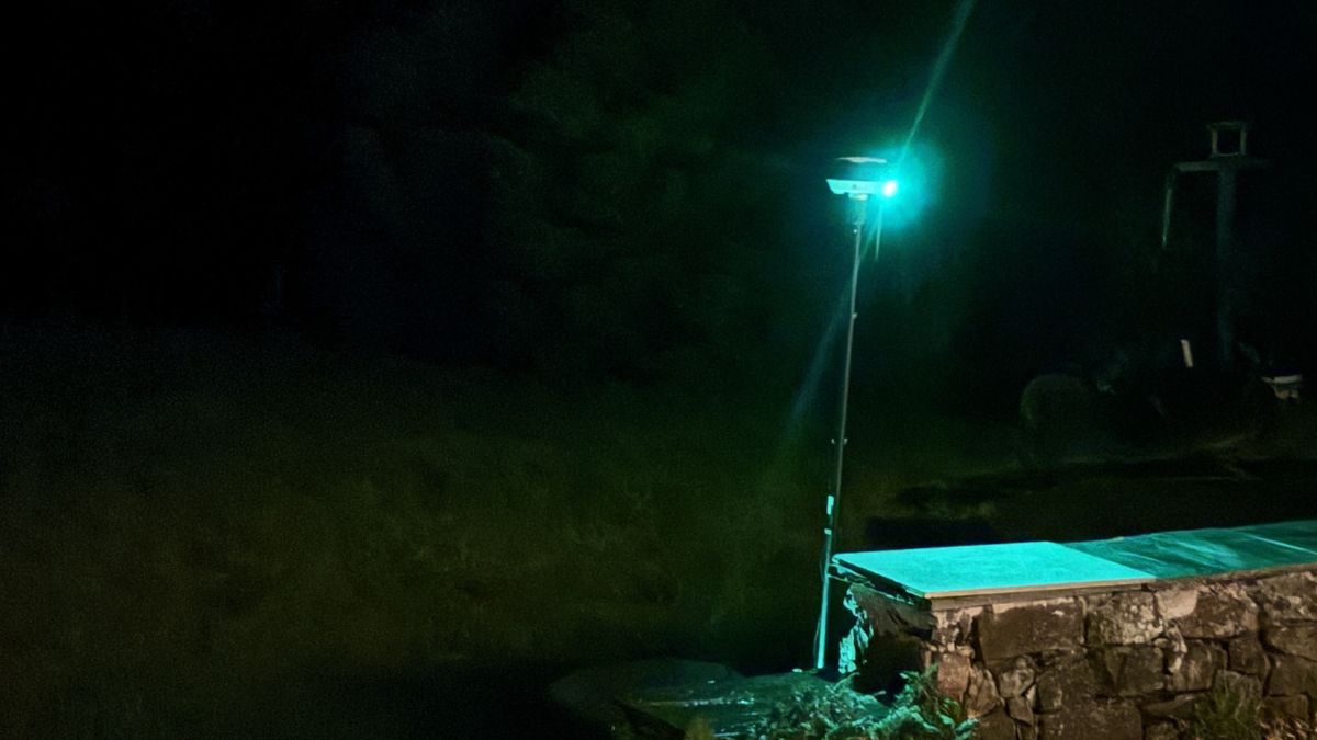 robot mower GPS station lit up at night