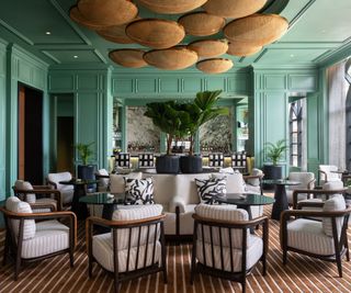 Green walls and ceiling hanging wicker, armchairs