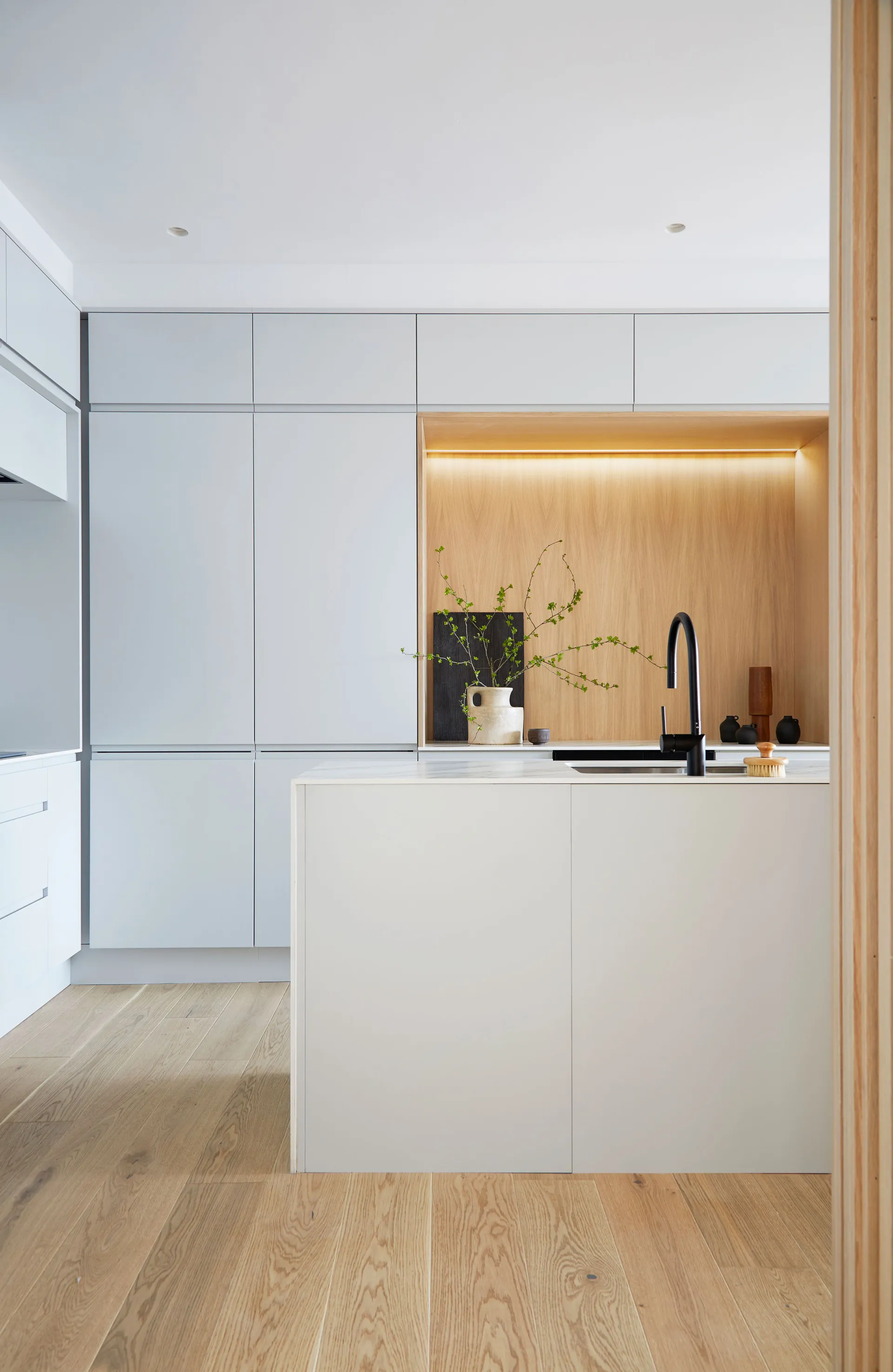 A sleek kitchen with white cabinets and modern accents