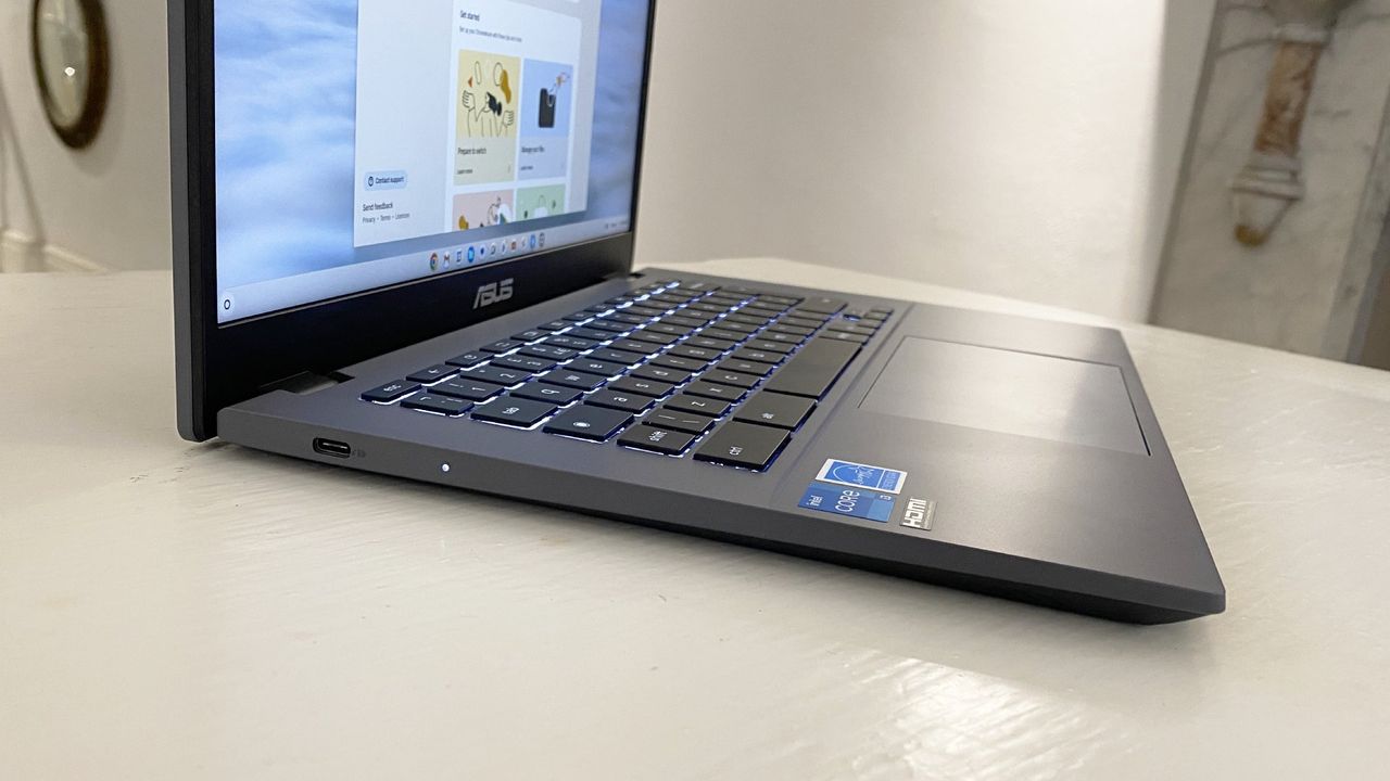 The Asus Chromebook Plus CX34 photographed on a white desk.