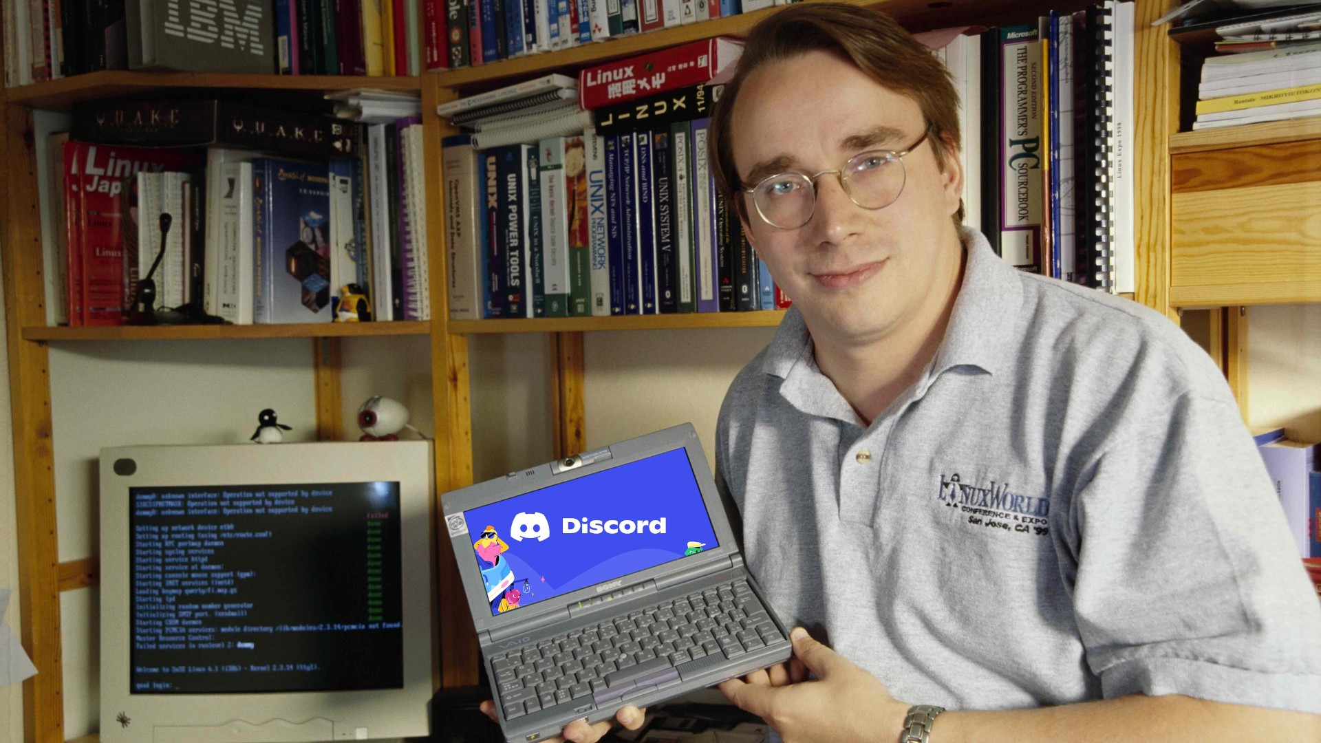 Linus Torvalds holds a small PC onto the screen of which Discord has been photoshopped clumsily.