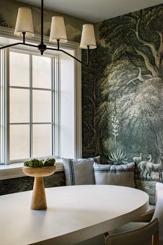 a dining room with a black and white mural