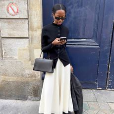 Influencer wearing a chic, minimal black and white outfit