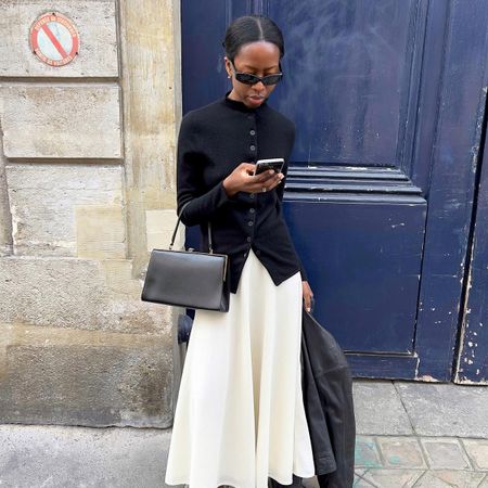 Influencer wearing a chic, minimal black and white outfit