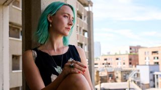 Rona (Saoirse Ronan) leans against a window in "The Outrun"