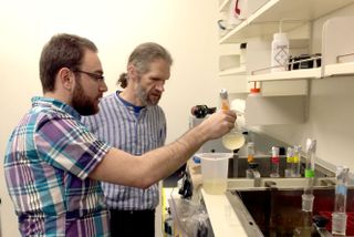 Ken Stedman (right) working in his lab. Stedman is a virologist and Chair of the NASA Astrobiology Institute’s Virus Focus Group.