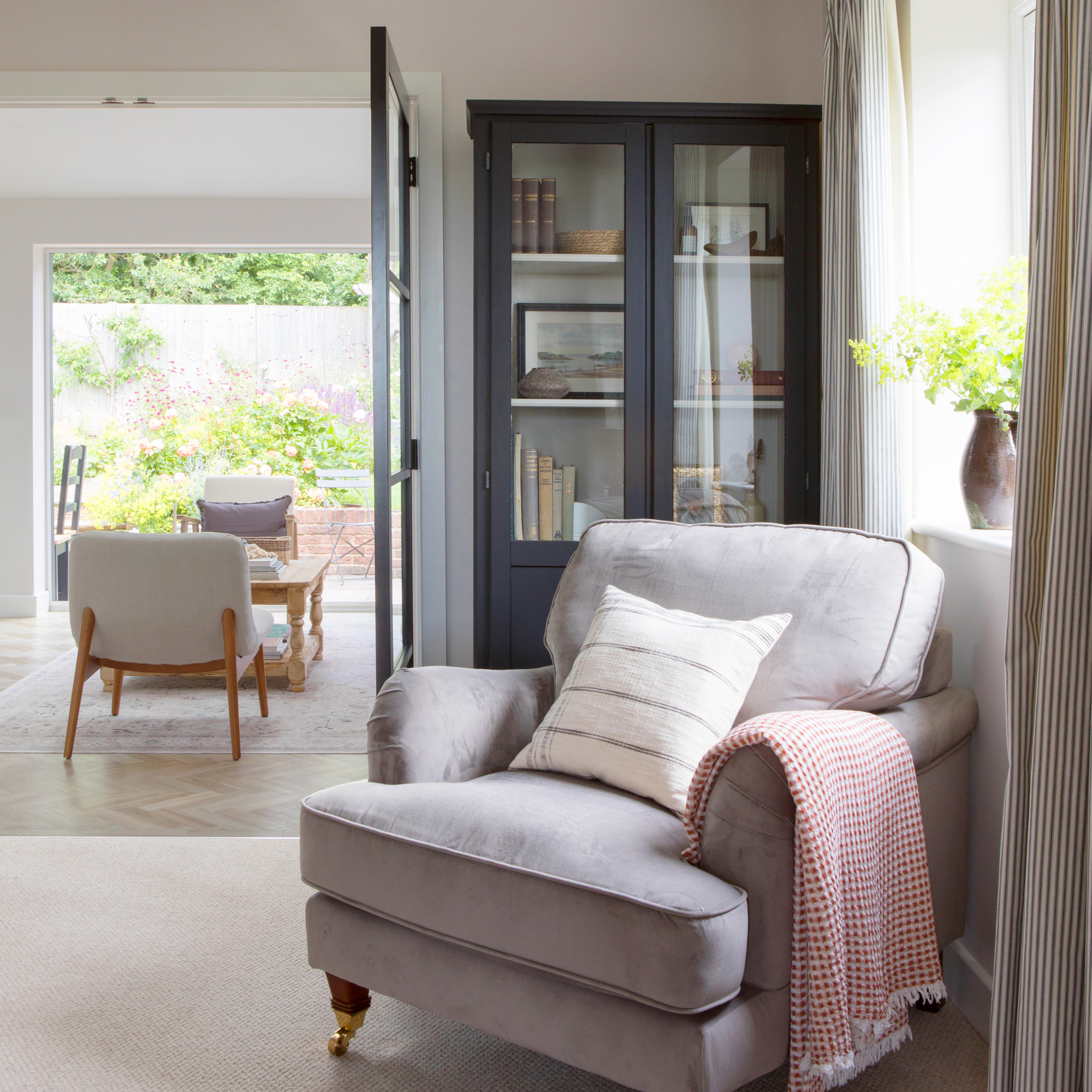 country cottage living space with classic armchair and neutral colour scheme