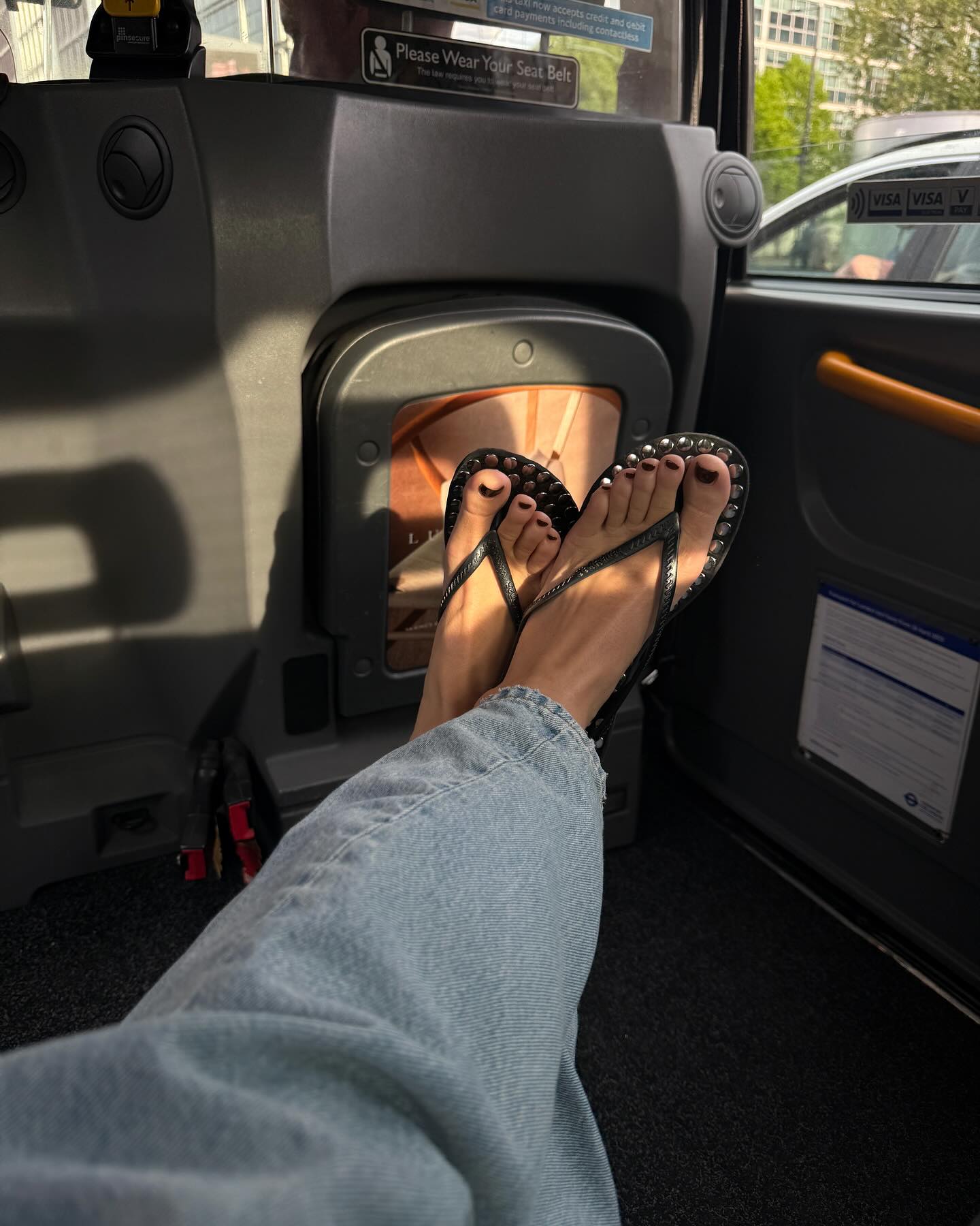 Influencer wears studded flip-flops.