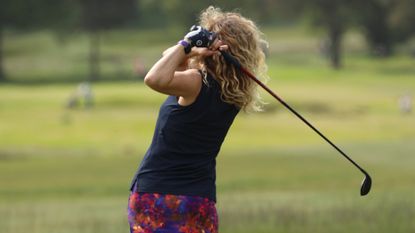 A woman hitting a tee shot