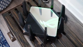 ASUS ROG Rapture GT-AXE16000 quad-band Wi-Fi 6E router from the top showing the mirror finish