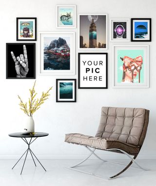 room with sofa chair and wall of art