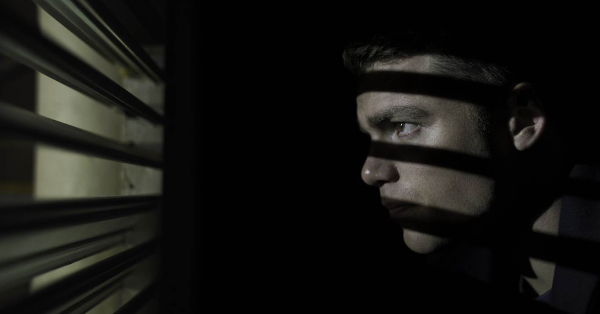 Peter Sutherland hides in a closet in season 1 of The Night Agent