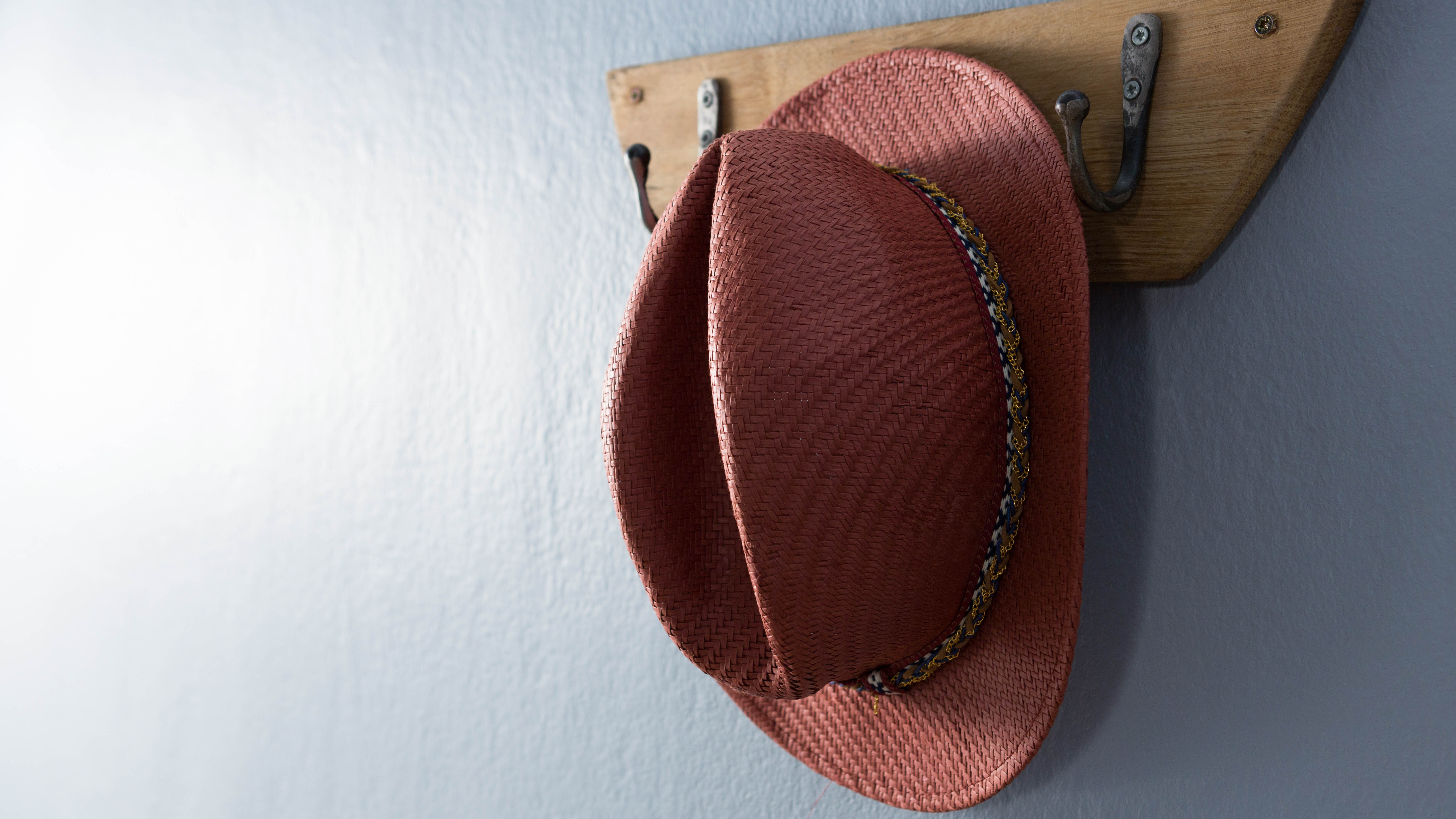 Straw hat hanging up on wall