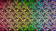 Rainbow colored iridescent semiconductor wafer extreme close-up studio shot.