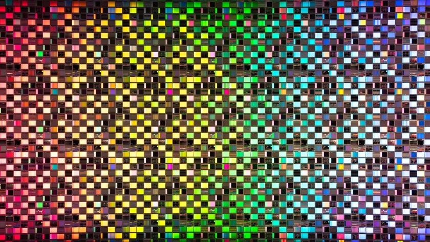 Rainbow colored iridescent semiconductor wafer extreme close-up studio shot.