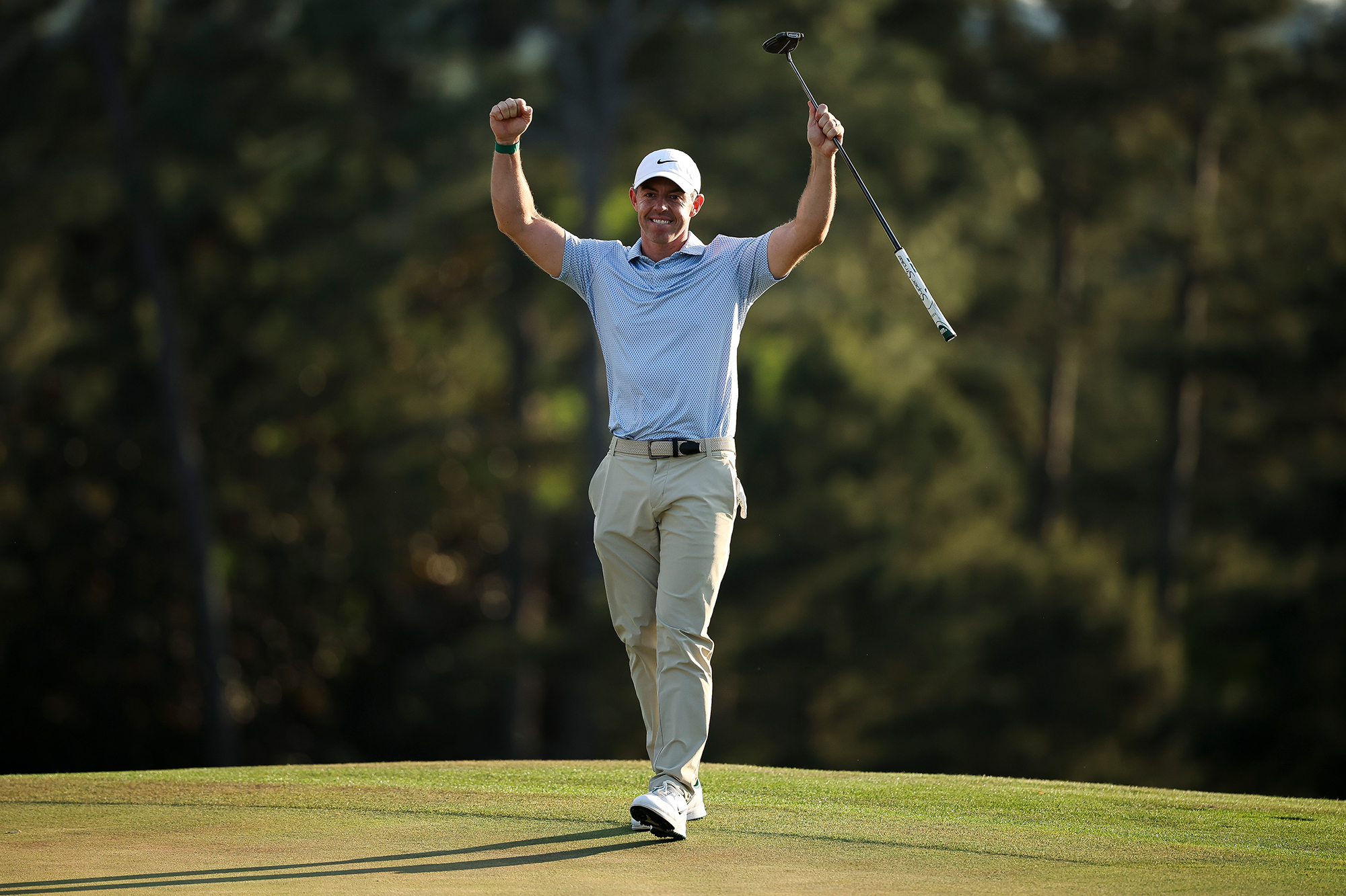Rory McIlroy celebrating with arms aloft after winning the 2026 Masters Tournament