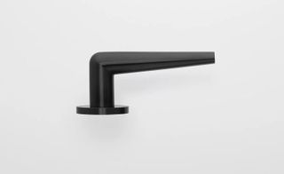 black minimalist door handle by Piet Boon seen from the side