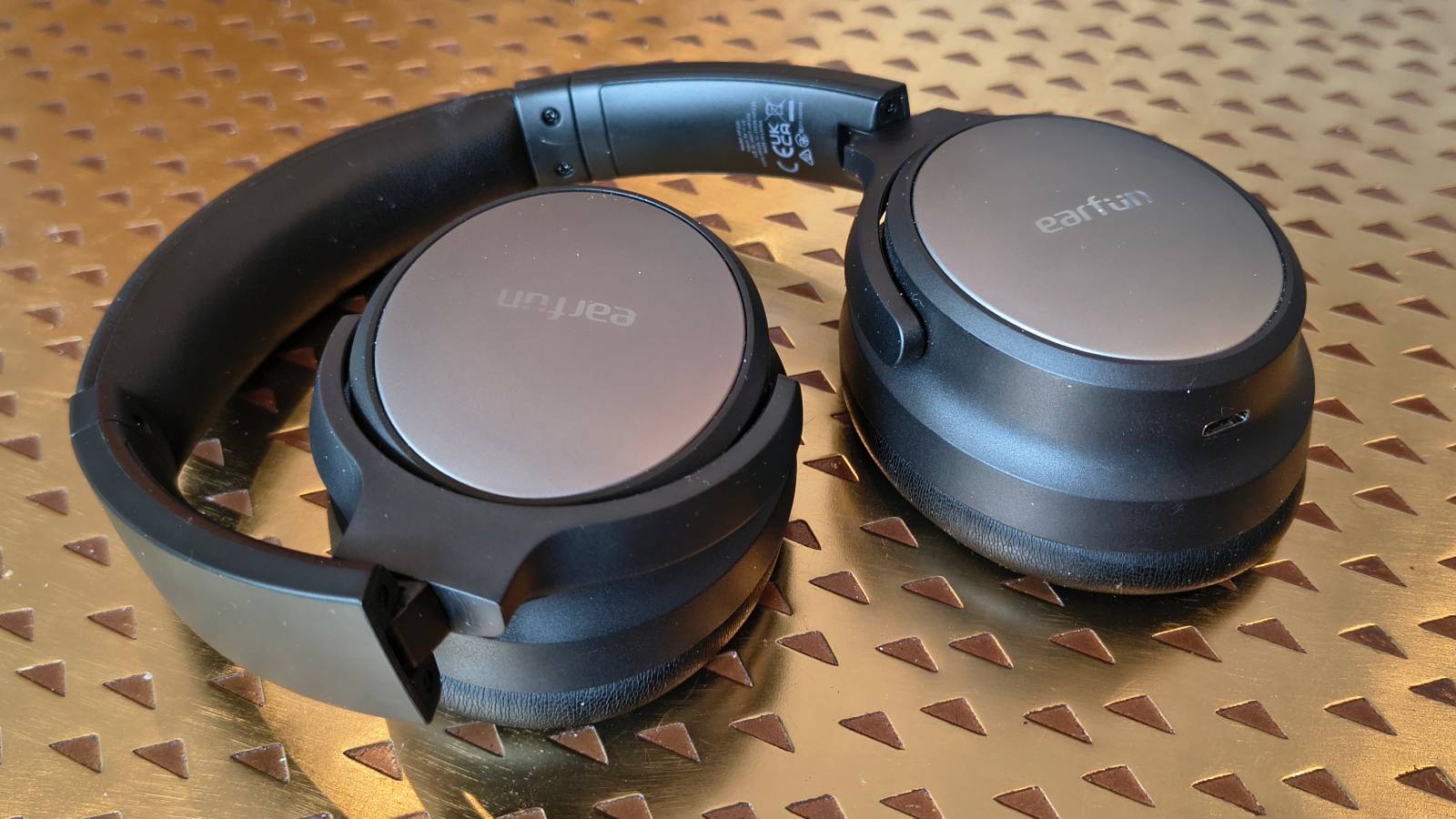 The Earfun Tune Pro atop a bronze table.