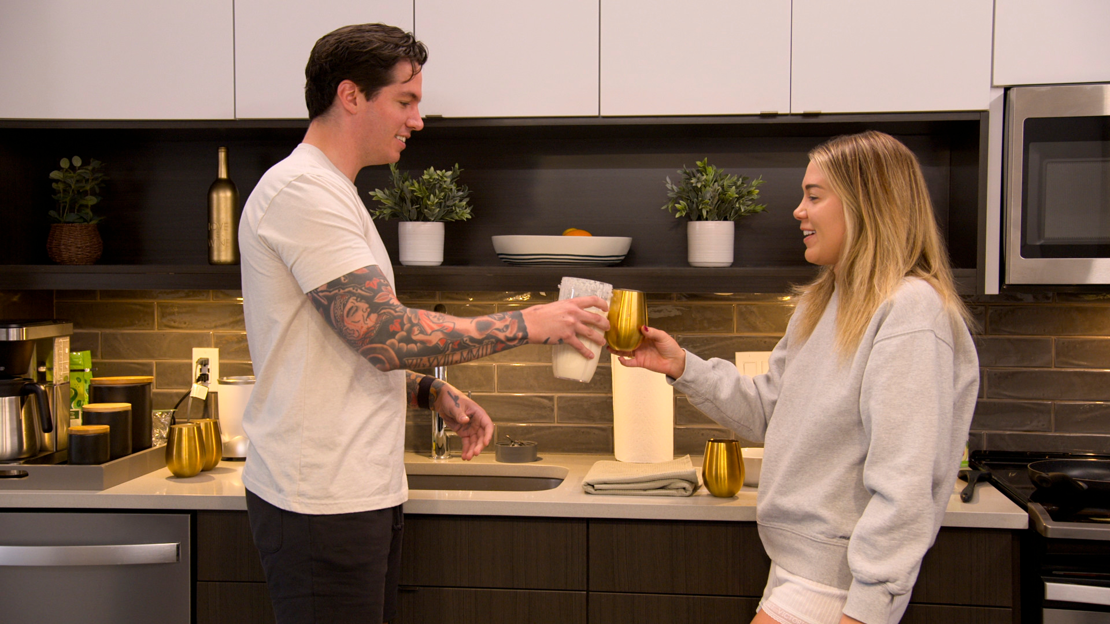 love is blind season 9 stars megan and jordan cheers glasses in their denver kitchen