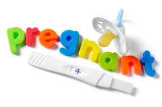 Magnetic letters spelling out pregnant