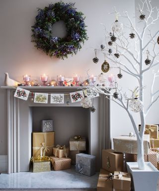 White room, with modern fireplace and presents inside, and white decorations