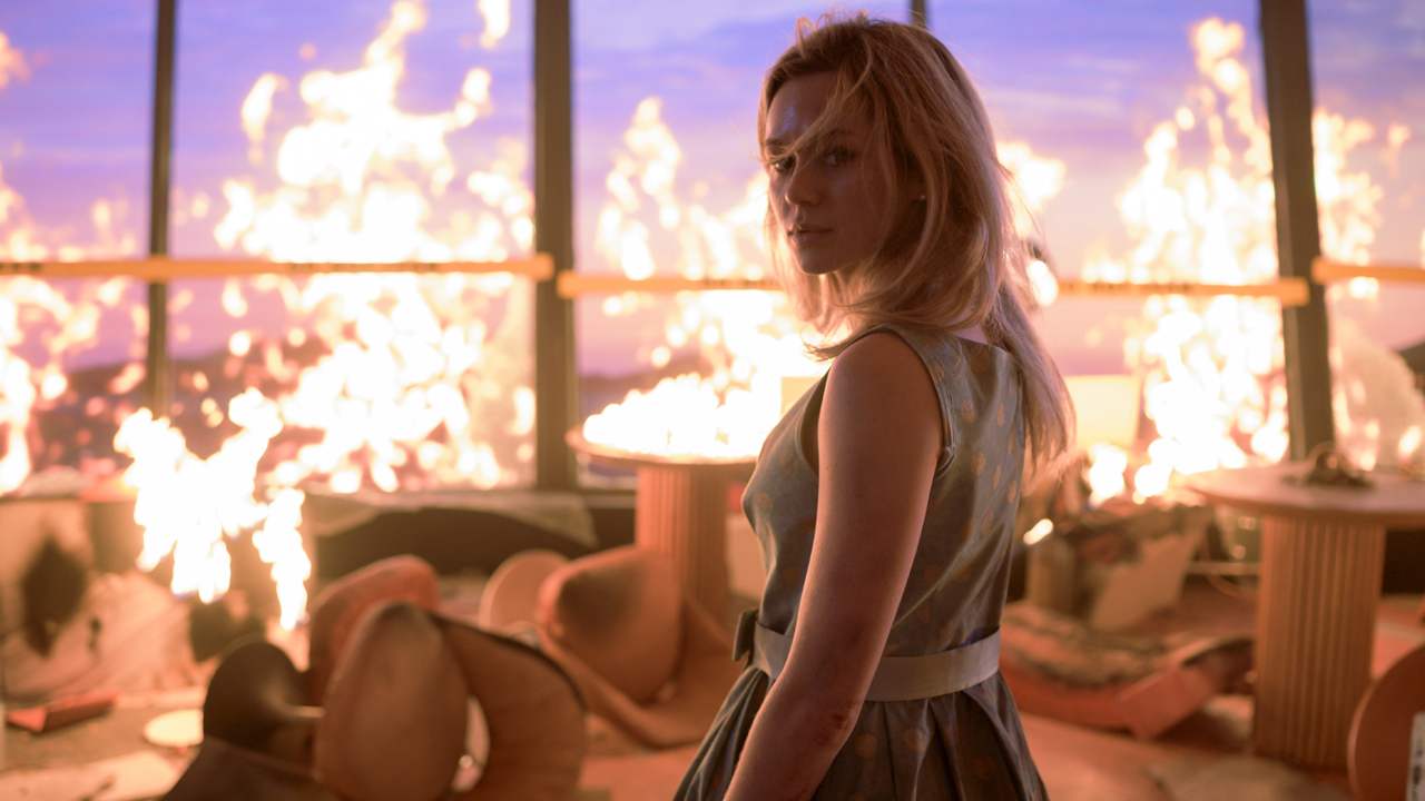 Brec Bassinger as Iris in a burning restaurant in Final Destination: Bloodlines