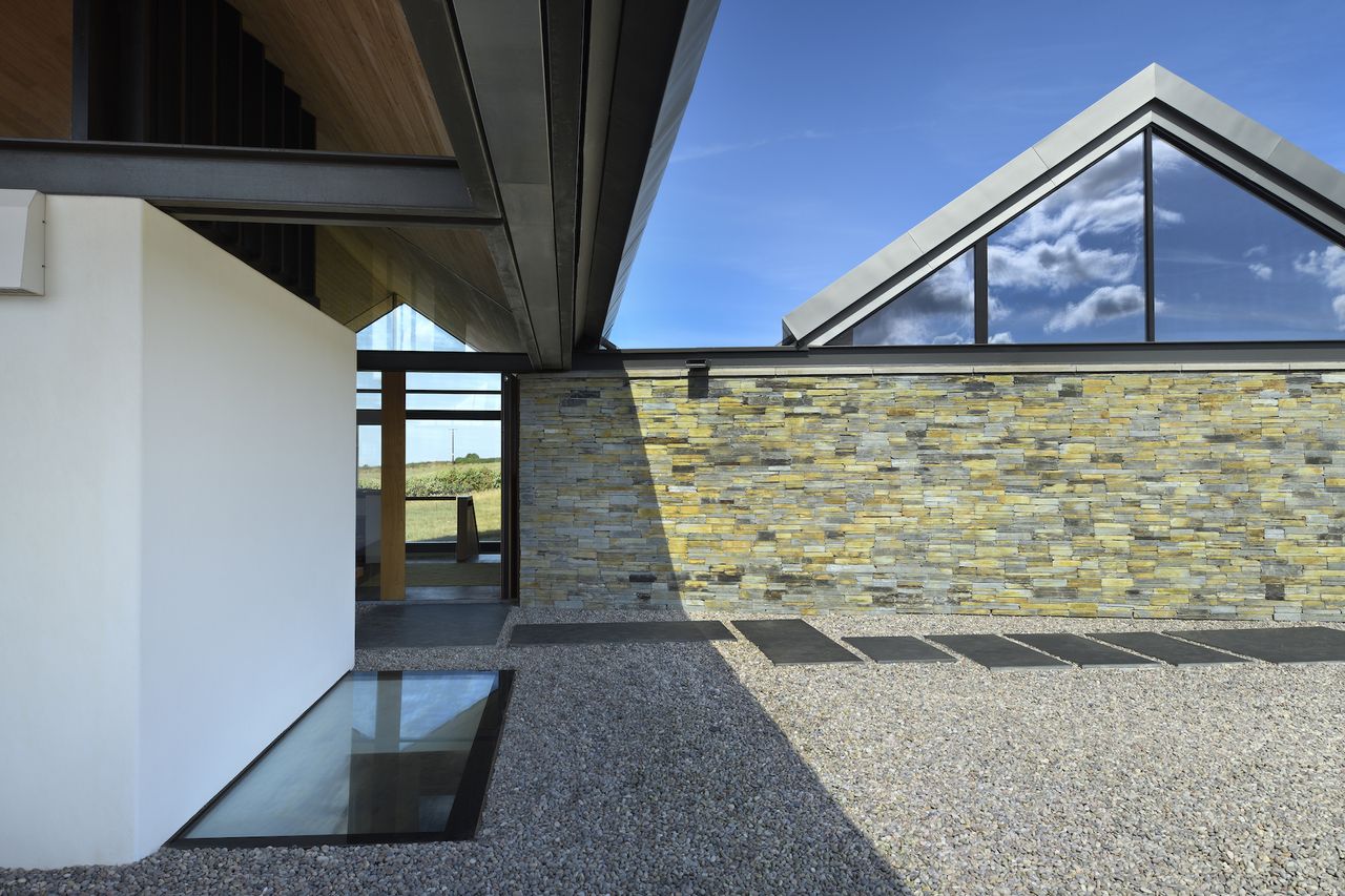 stone entrance to a house with walk on rooflight