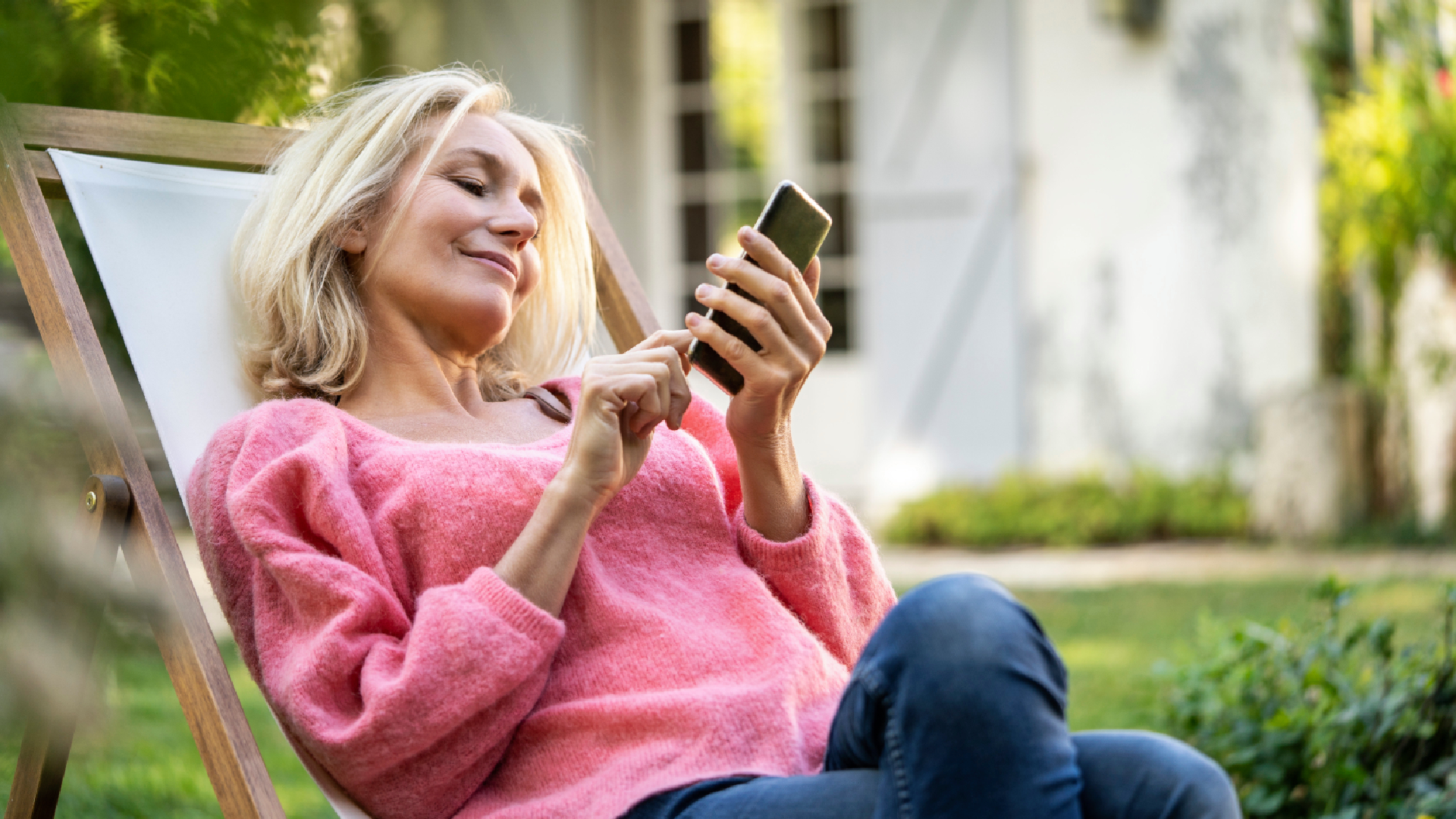 woman using phone in the garden