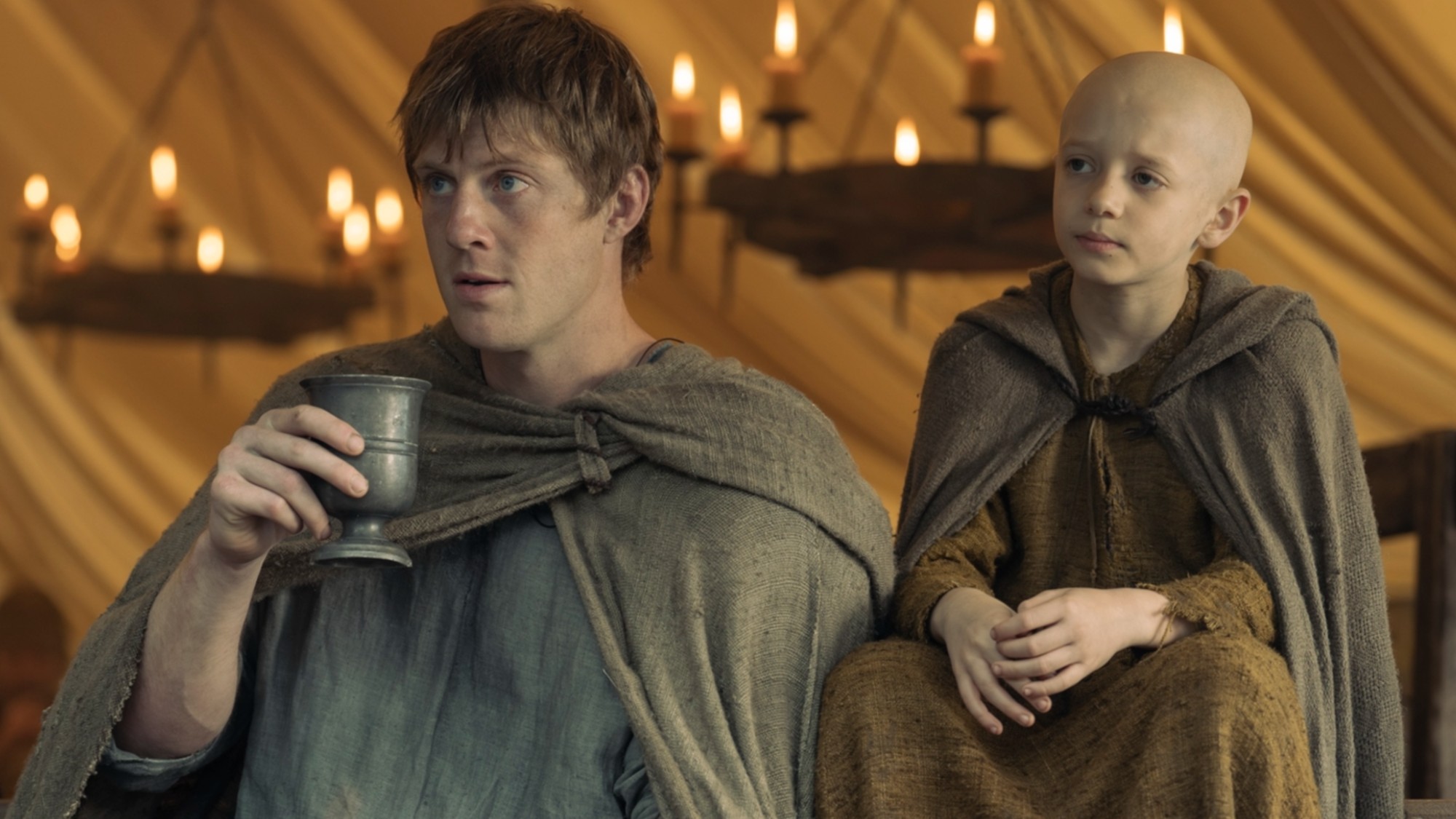 Dunk and Egg sitting next to each other on A Knight of the Seven Kingdoms.