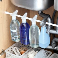 Bottles of cleaning products under sink