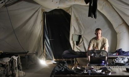 A U.S. army soldier in an Afghanistan housing tent: One expert's estimate says the U.S. military's air conditioning bill for Afghanistan and Iraq will exceed NASA's 2011 budget.