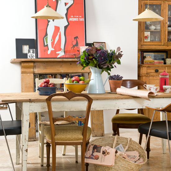 room with white wall and old and new accessories with dining table
